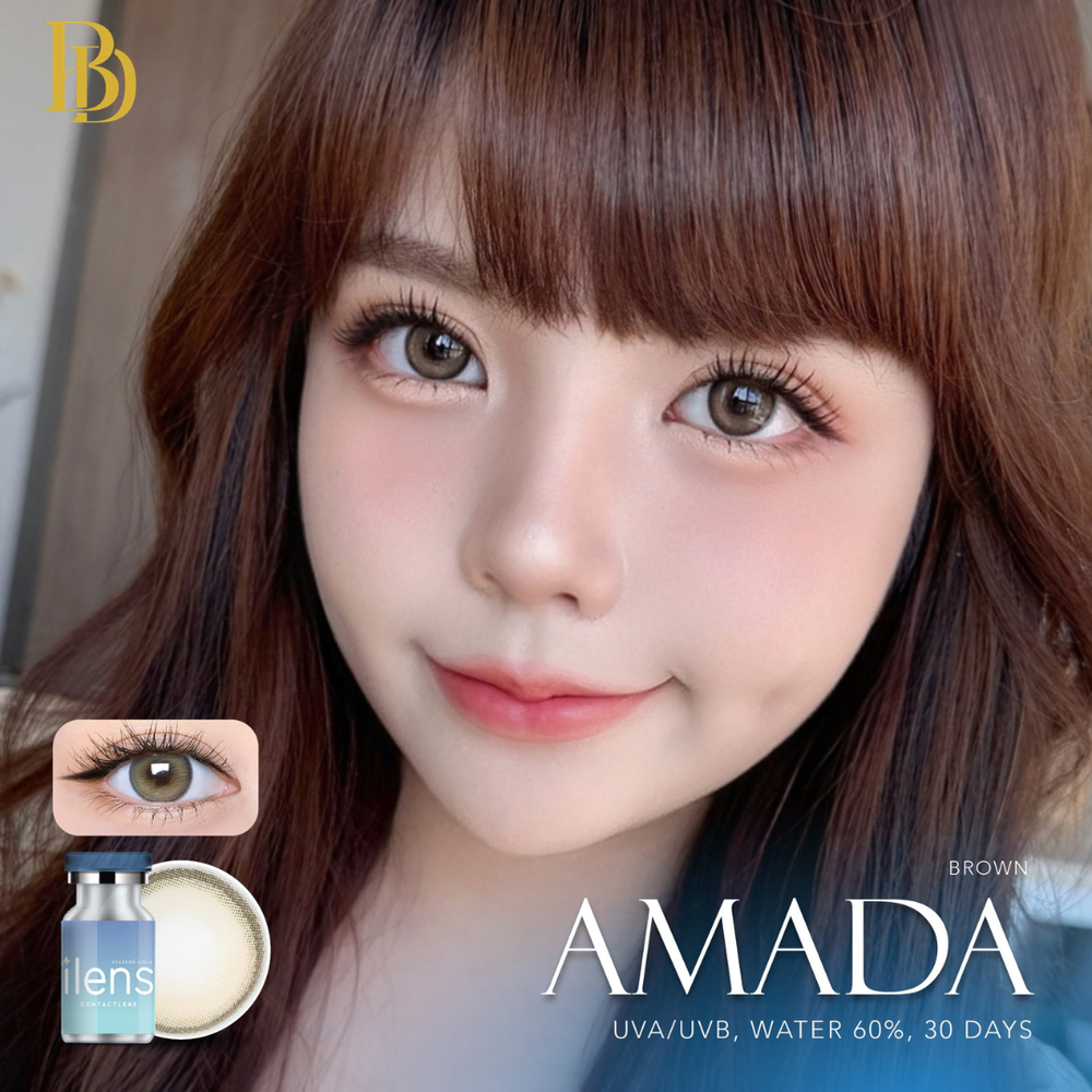 Close-up of a person with brown hair and eyes, featuring AMADA contact lenses packaging.