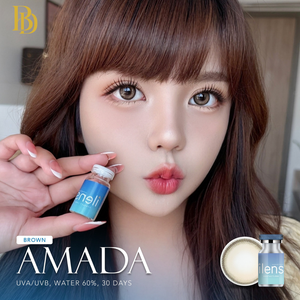 Woman holding a bottle labeled 'Amada' with product details on a blurred indoor background