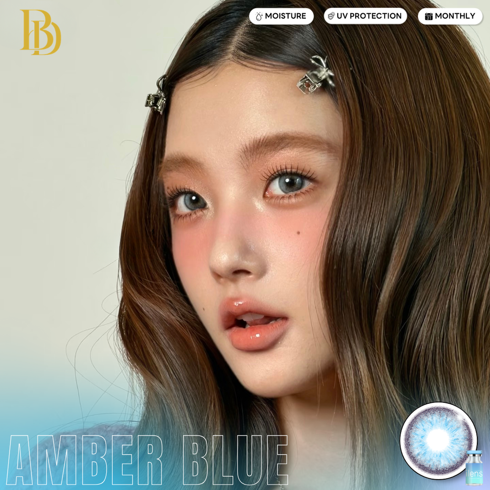 Close-up of a person with long brown hair and blue eyes, featuring product labels on a light background.
