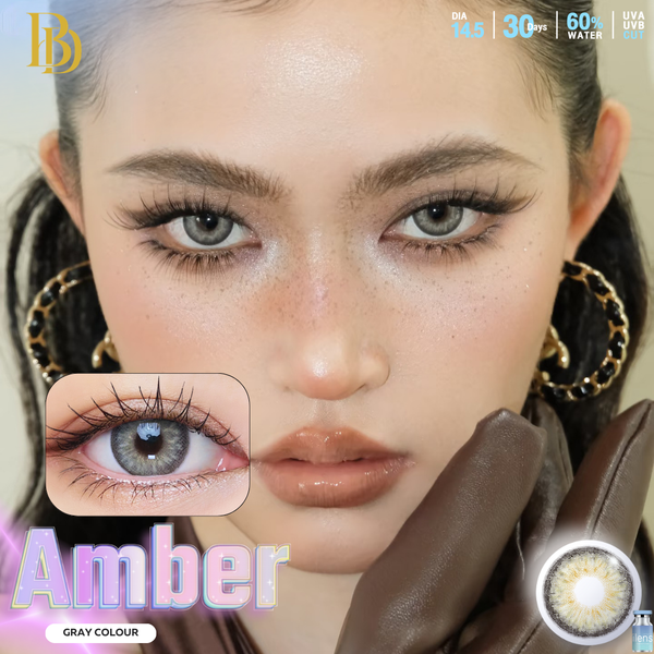 Close-up of a person wearing amber-colored contact lenses with product details.