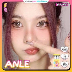 Close-up of a person with purple hair and a product labeled 'ANLE' on a pink background.