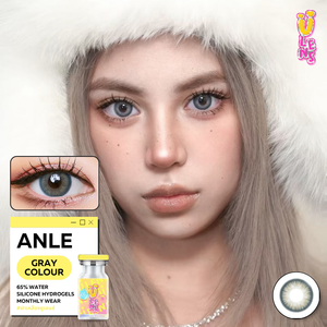 Person wearing a white fur hat with contact lens packaging and contact lenses displayed.