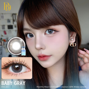 Woman wearing pearl earrings with ilens contact lenses and solution inset, labeled 'Baby Gray'.