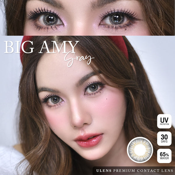 Advertisement for Big Amy gray contact lenses showing a close-up of eyes with colored lenses and product packaging details.