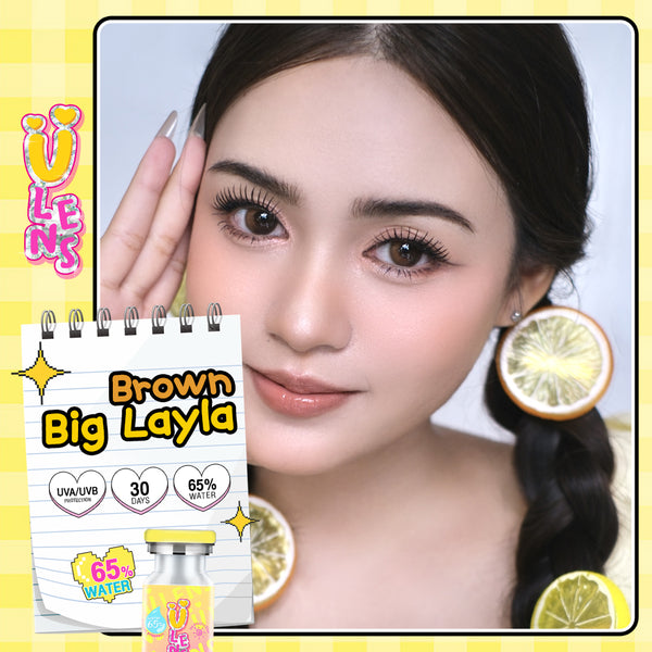 Woman with long eyelashes and a product labeled 'Brown Big Layla' on a yellow background