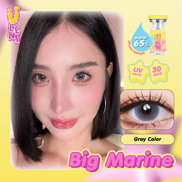 Person wearing gray colored contact lenses with product packaging and branding on a yellow background