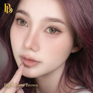 Close-up of a person with purple hair and 'Big Mellow Brown Contact Lenses' text