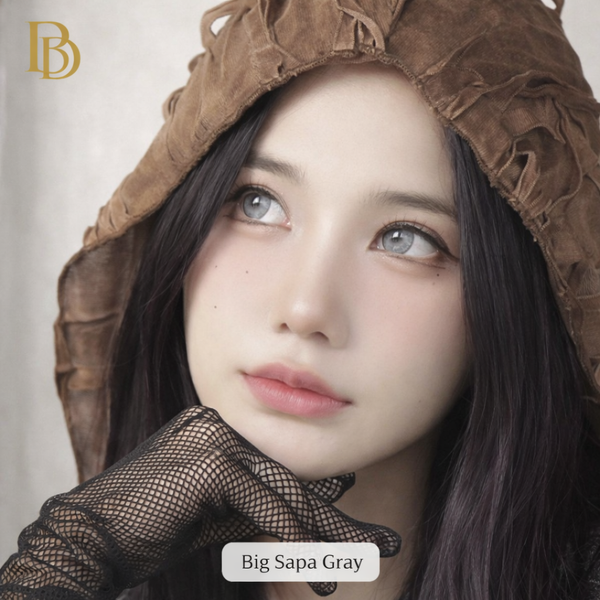 Person wearing a brown hood and black gloves with 'Big Sapa Gray' branding.