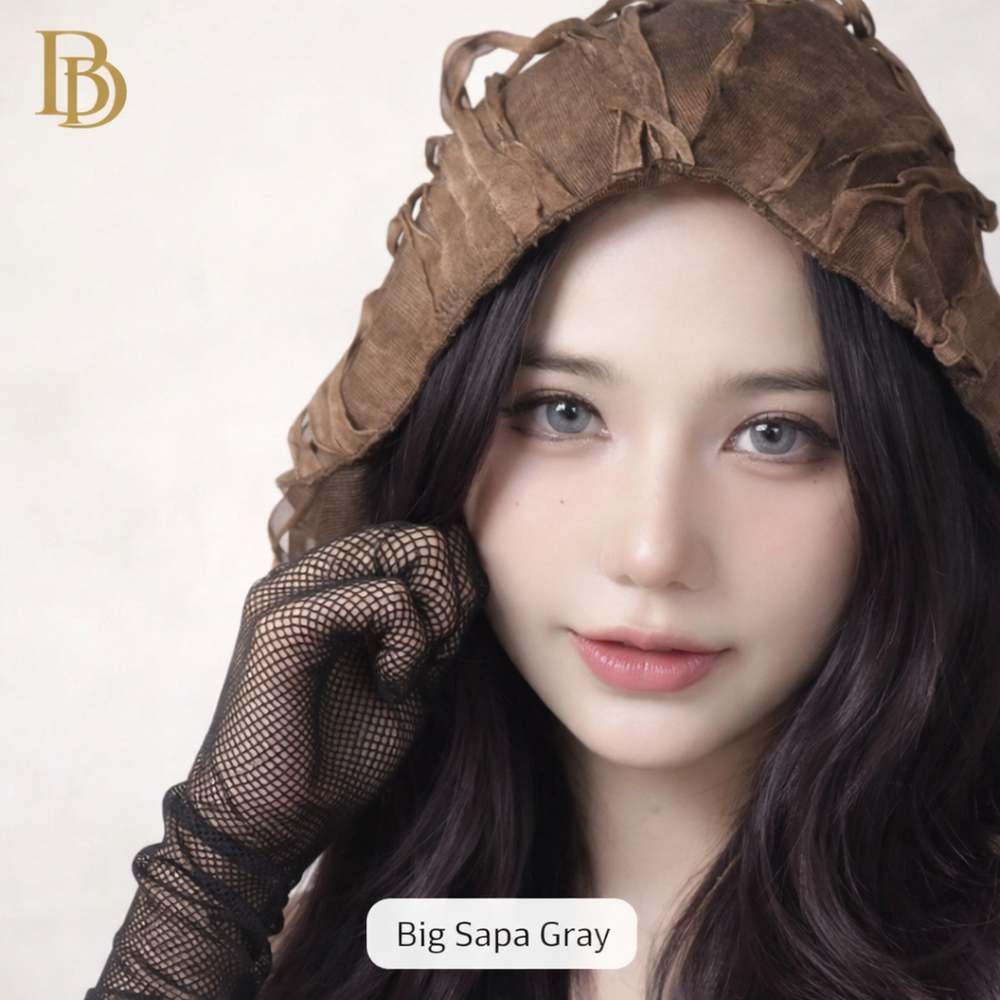 Person wearing a brown hood and black gloves with 'Big Sapa Gray' branding.