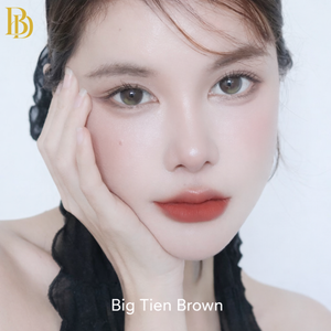 Close-up of a person with a neutral expression on a white background, featuring the brand 'Big Tien Brown'.