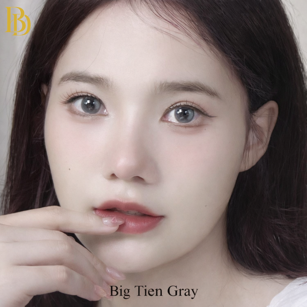 Close-up of a person with a neutral expression, featuring the brand 'Big Tien Gray'.