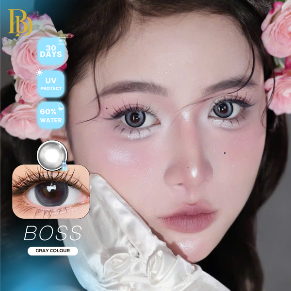 Close-up of a person wearing Boss Gray contact lenses, with product features displayed.