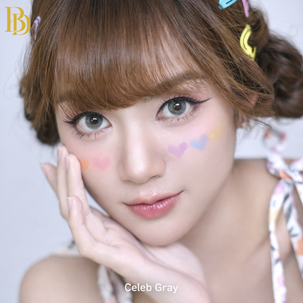 Close-up of a person with colorful hair clips and pastel makeup on a light background
