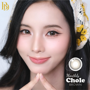 Close-up of a person with dark hair and a decorative headband, featuring the 'Monthly Chole' brand.