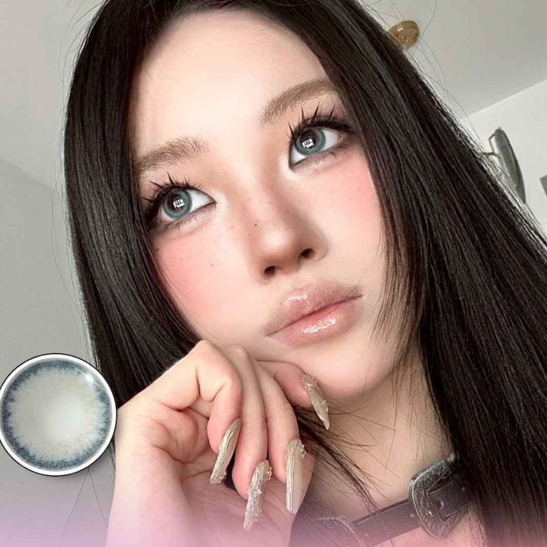 Woman with long dark hair and blue eyes holding a contact lens case.