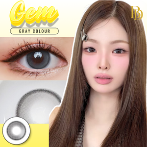 Close-up of a person with brown hair and makeup With a clear image of Gem Gray Contact Lenses