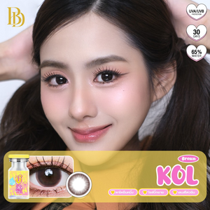 Close-up of a model with contact lenses and a contact lens box labeled 'KOL' on a white background.