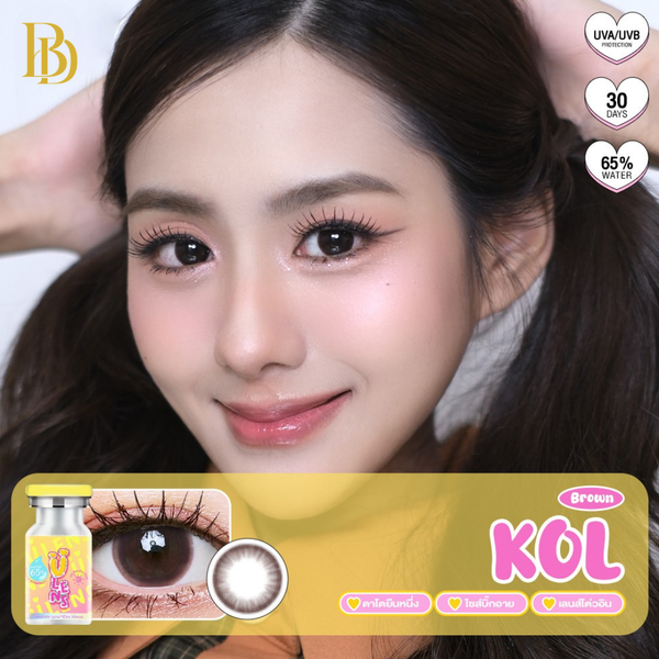 Close-up of a model with contact lenses and a contact lens box labeled 'KOL' on a white background.