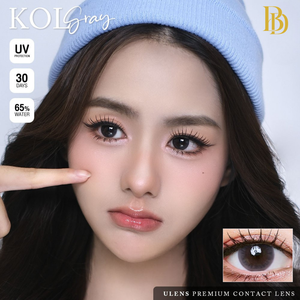 Person wearing a blue beanie with contact lens advertisement text and image.