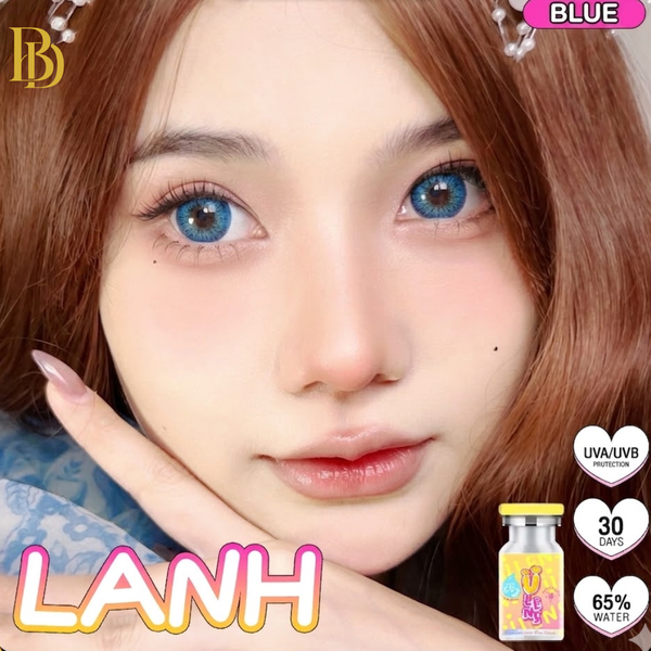Person with blue eyes and brown hair, wearing a blue top, with 'LANH' branding and product packaging.
