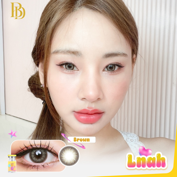 Close-up of a person with brown contact lenses, featuring a brand logo on the left.