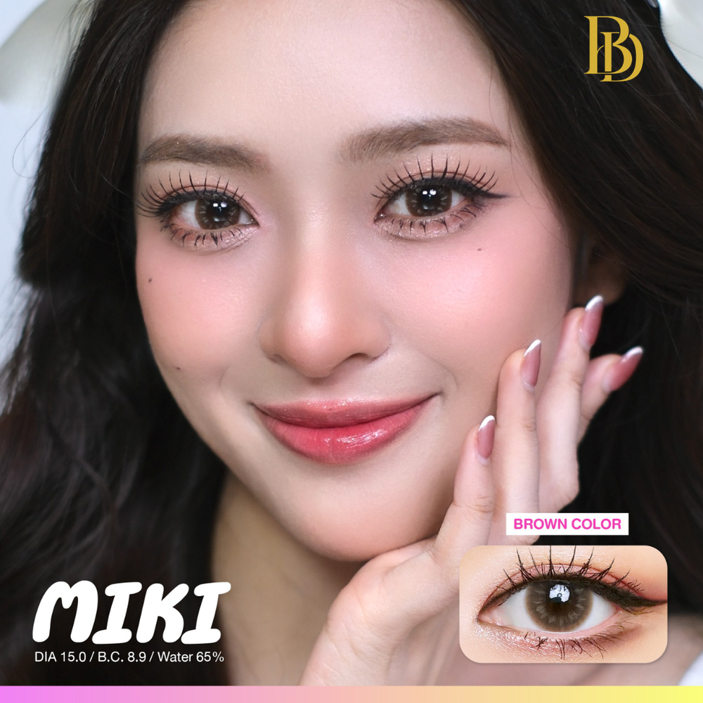 Close-up of a woman with brown contact lenses, showing the brand 'MIKI'.