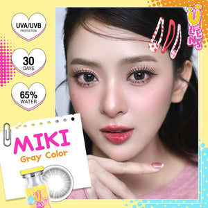 Advertisement for Miki gray color fashion contact lenses by U Lens with a model wearing them, UVA/UVB protection, and water content information.