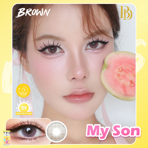 Advertisement for brown contact lenses with a woman's face and a guava slice, featuring the brand 'My Son'.