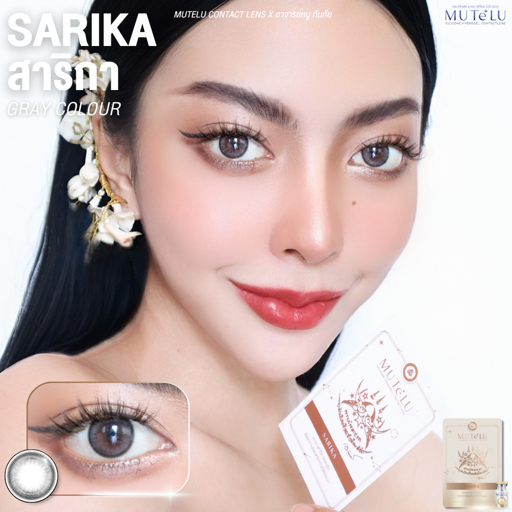 Woman holding Sarika Gray contact lens packaging with close-up of eyes wearing gray lenses.