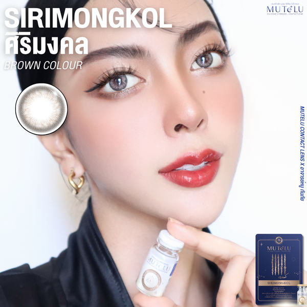 Person holding contact lens solution bottle with contact lenses and packaging displayed