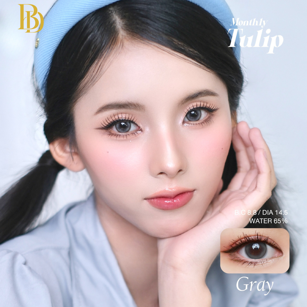 Model wearing gray contact lenses with product details on a light blue background