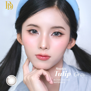 Close-up of a person with styled hair and makeup, featuring the brand 'BB'.