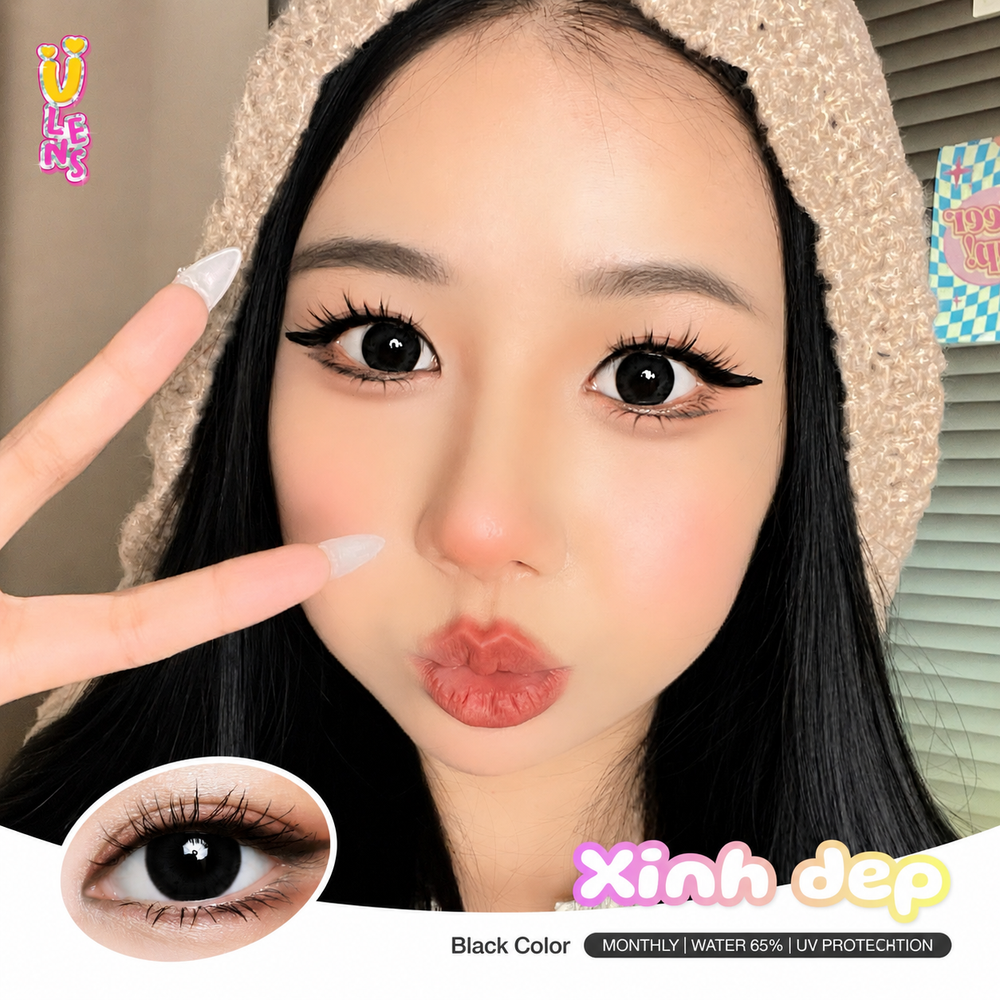 Close-up of a person with long eyelashes and a black contact lens, with 'Xinh dep' branding.