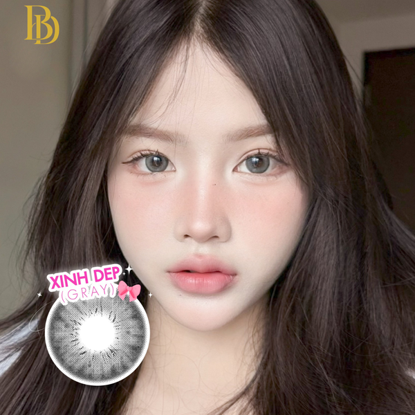 Close-up of a person with long dark hair, featuring a contact lens advertisement in the corner.